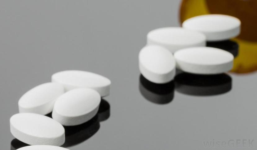 white-tablet-pills-on-reflective-surface